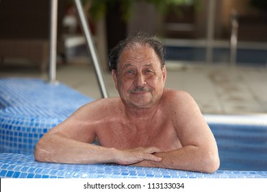 Portrait Of Mature Man Smiling In Swimming Pool.