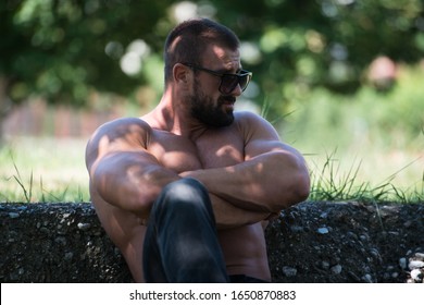 Portrait Of A Mature Physically Fit Tattoo Man Showing His Well Trained Body - Muscular Athletic Bodybuilder Fitness Model Posing After Exercises