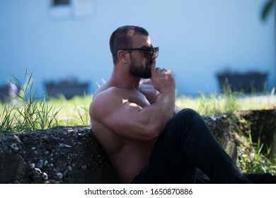 Portrait Of A Mature Physically Fit Tattoo Man Showing His Well Trained Body - Muscular Athletic Bodybuilder Fitness Model Posing After Exercises