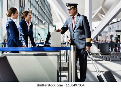 Portrait Of Mature Pilot Talking With The Airport Staffs In Boarding Gate