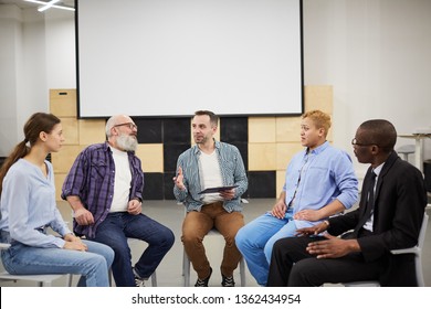 Portrait of mature psychologist leading therapy session in support group, copy space - Powered by Shutterstock