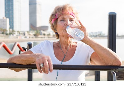 Portrait of mature sportswoman drinking water - Powered by Shutterstock