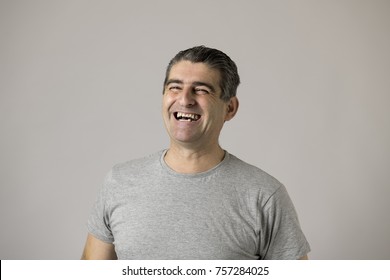 Portrait Of Mature White Man 40 To 50 Years Old Smiling And Laughing Happy And Excited Showing Nice And Positive Face Expression Isolated On Grey Background In Feelings And Emotions Concept
