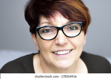 Portrait Of Mature Woman In Black Glasses