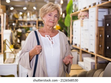 Portrait Of Mature Woman Choosing New Goods In A Home Decor Store