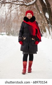 Portrait Of Mature Woman In Coat And Red Cap In Winter