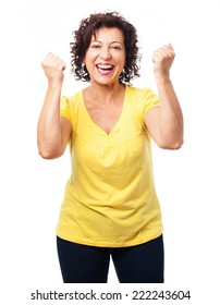 portrait of a mature woman doing a winner gesture on a white background