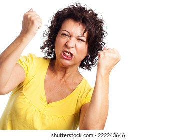 portrait of a mature woman doing a winner gesture on a white background