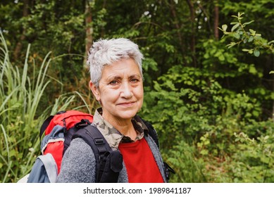 Portrait Of Mature Woman Hiker With Grey Hair In The Forest. Healthy Lifestyle Pensioner.