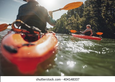 Portrait of mature woman kayaking in lake on a sunny day. Couple canoeing in a lake on  summer day. - Powered by Shutterstock