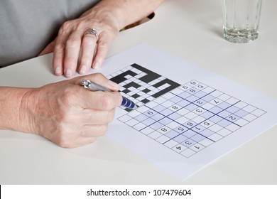 Portrait Of Mature Woman Playing Sudoku Puzzle.