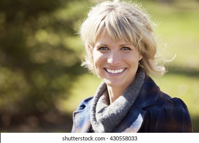 Portrait Of A Mature Woman Smiling At The Camera Outside