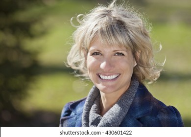 Portrait Of A Mature Woman Smiling At The Camera Outside