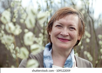 Portrait Of Mature Woman In Spring Pussywillow Plant