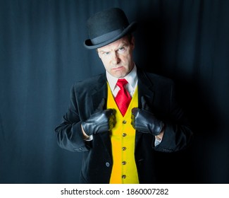 Portrait of Mean-Looking Man in Dark Suit and Leather Gloves. Concept of Comic Book Villain or Thug. Vintage Fashion. Retro Style. Menacing and Scowling. Sharp Dressed Man. Mafia Hit Man.