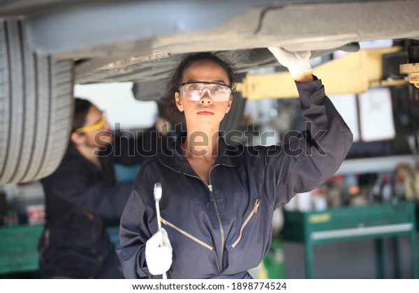 Portrait\
of a mechanic at work in his garage or car repair service or auto\
store, business, maintenance and people\
concept