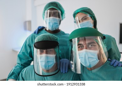 Portrait of medical doctors looking at camera inside laboratory hospital during coronavirus outbreak - Focus on right man face - Shutterstock ID 1912931338