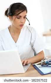 Portrait Of Medical Secretary Typing Report