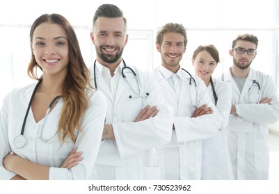 Portrait of medical team standing with arms crossed in hospital