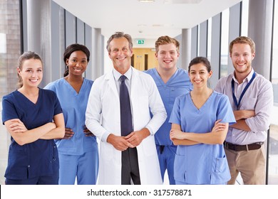 Portrait Of Medical Team Standing In Hospital Corridor - Powered by Shutterstock