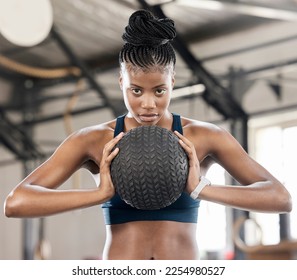 Portrait, medicine ball or black woman in training, workout or exercise for balance or strengthen muscles. Focused girl, mindset or healthy African athlete with goals, motivation or focus at gym - Powered by Shutterstock