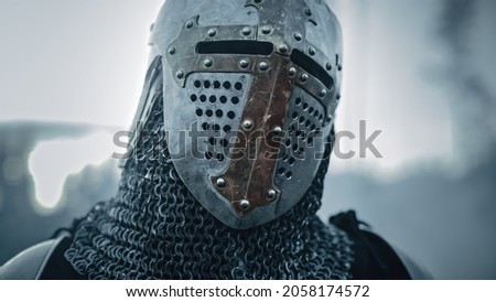 Portrait of a Medieval Knight on Battlefield, Closed Helmet Ready for Battle. Portrait of Mighty Warrior, King, Soldier at War, Conquest, Crusade. Dramatic Scene, Cinematic Historic Reenactment