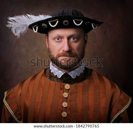 Portrait of medieval man in vintage clothing on dark background.