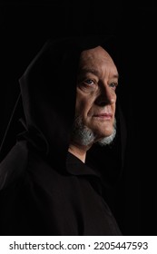 Portrait Of Medieval Monk In Hooded Robe Isolated On Black