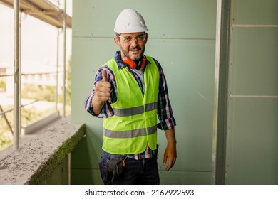 Portrait of men in 40s, construction worker. He is standing in construction and posing for camera.