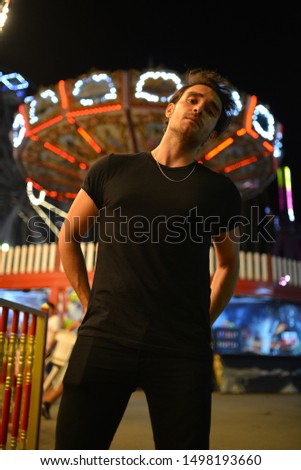 portrait of men with black t-shirt in the fun fair