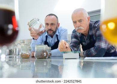 portrait of men checking barley seeds - Powered by Shutterstock