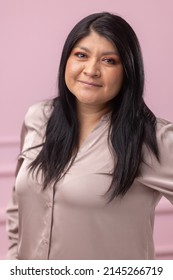 Portrait Of A Mexican Empowered Woman Isolated On Pink Background