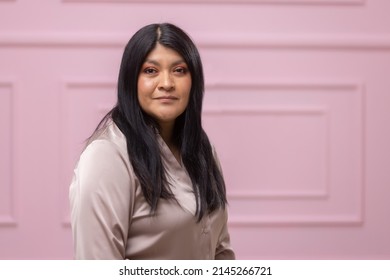 Portrait Of A Mexican Empowered Woman Isolated On Pink Background