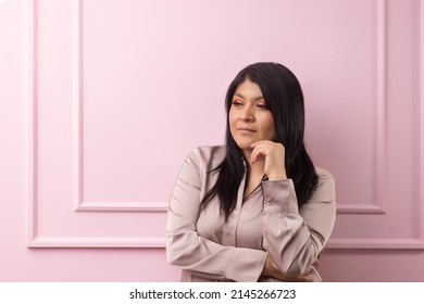 Portrait Of A Mexican Empowered Woman Isolated On Pink Background