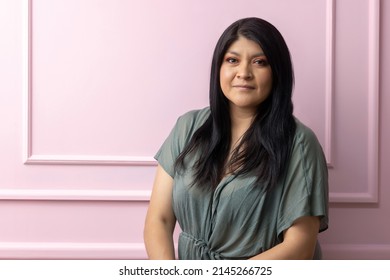 Portrait Of A Mexican Empowered Woman Isolated On Pink Background