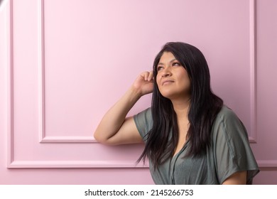 Portrait Of A Mexican Empowered Woman Isolated On Pink Background