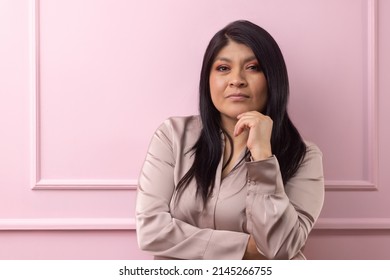 Portrait Of A Mexican Empowered Woman Isolated On Pink Background