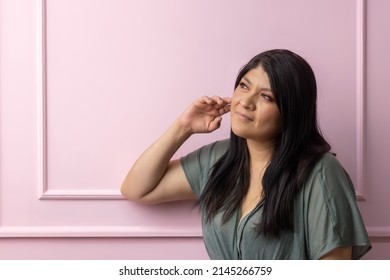 Portrait Of A Mexican Empowered Woman Isolated On Pink Background