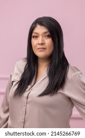 Portrait Of A Mexican Empowered Woman Isolated On Pink Background