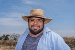 A Portrait Of A Mexican Happy Farmer Collecting Corn