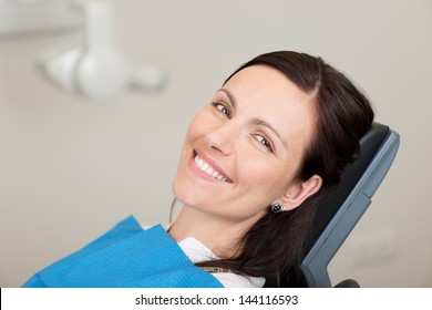 Portrait Of Mid Adult Female Patient Smiling In Dentistry