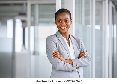 Portrait of mid adult successful black mature woman looking at camera with arms crossed. Smiling african american business woman standing in new office with copy space. Portrait of mature woman. - Powered by Shutterstock