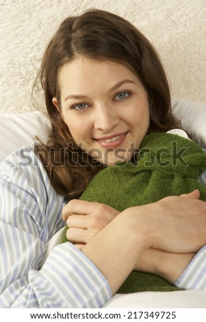 Portrait of a mid adult woman reclining on the bed and smiling