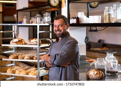 Portrait of mid age male baker standing at bakery. - Powered by Shutterstock