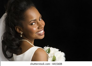 Portrait Of A Mid-adult African-American Bride On Black Background.