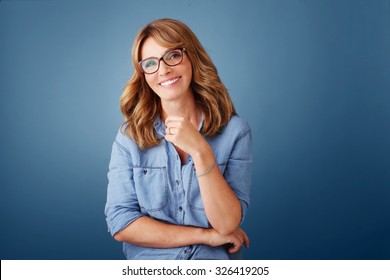 Portrait Of Middle Age Woman Looking At Camera And Smiling While Standing Against Isolated Background. 