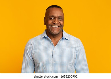 Portrait Of Middle Aged African American Man With Happy Smile, Orange Background