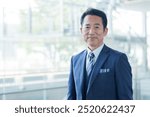 portrait of middle aged asian businessman in office