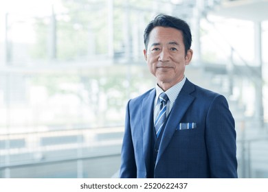 portrait of middle aged asian businessman in office - Powered by Shutterstock