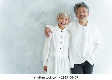 portrait of middle aged asian couple in white room - Shutterstock ID 2183408409